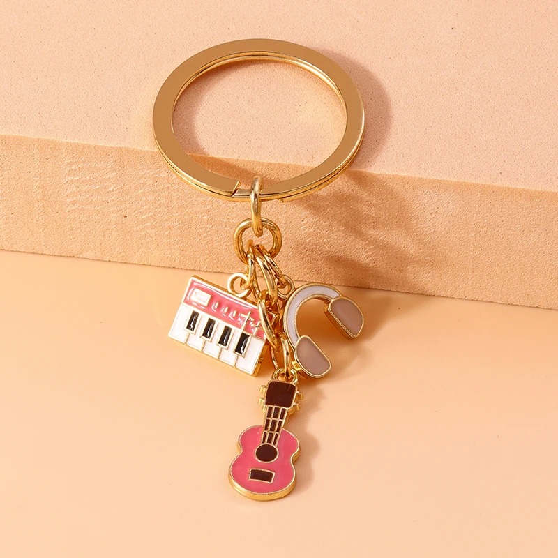 Llavero de guitarra e instrumentos musicales de metal en color rosa