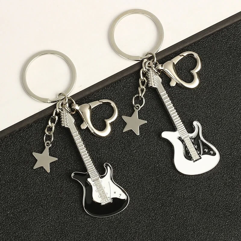 Llavero de guitarra eléctrica con encanto de estrella y mosquetón en forma de corazón